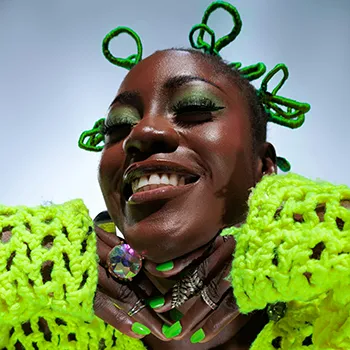 a beautiful black woman dressed in bright green