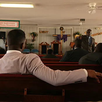 a man listens to a sermon in church