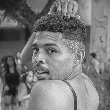 a black queer man looks over his shoulder