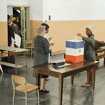 a woman casts her ballot on election day